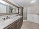 Updated bathroom featuring double sinks, a walk-in shower, a walk-in tub, and laundry machines at 379 Harbor Isles Dr, North Port, FL 34287