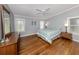 Comfortable bedroom featuring hardwood floors, ceiling fan, and natural light from two windows at 379 Harbor Isles Dr, North Port, FL 34287