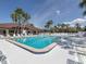 Well-maintained community pool surrounded by ample seating and lush landscaping on a clear day at 379 Harbor Isles Dr, North Port, FL 34287