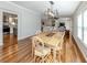 Bright dining room featuring hardwood floors, modern chandelier, and easy access to the kitchen and living room at 379 Harbor Isles Dr, North Port, FL 34287