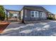 Inviting exterior with charming gray siding, a covered porch, and well-kept landscaping and walkway at 379 Harbor Isles Dr, North Port, FL 34287