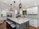 Bright kitchen featuring granite countertops, white cabinets, stainless steel appliances and hardwood floors at 379 Harbor Isles Dr, North Port, FL 34287