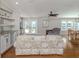 Bright and spacious living room featuring hardwood floors, a ceiling fan, and plenty of natural light at 379 Harbor Isles Dr, North Port, FL 34287