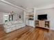 Cozy living room featuring hardwood floors, built-in bar, and plenty of natural light for relaxing at 379 Harbor Isles Dr, North Port, FL 34287