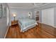 Comfortable main bedroom featuring hardwood floors, a ceiling fan, and a closet for ample storage at 379 Harbor Isles Dr, North Port, FL 34287
