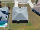 Aerial view of the home and neighboring property, highlighting the roof, lawn, and private pool in the adjacent yard at 4062 Green Tree Ave, Sarasota, FL 34233