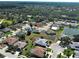 This aerial shows a quiet neighborhood with a beautiful pond nearby the home in a serene and peaceful setting at 4062 Green Tree Ave, Sarasota, FL 34233