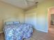Inviting bedroom with a ceiling fan, wood-look floors, and closet providing ample storage at 4062 Green Tree Ave, Sarasota, FL 34233