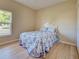 Cozy bedroom features wood-look floors and a comfortable bed, creating a welcoming retreat at 4062 Green Tree Ave, Sarasota, FL 34233