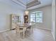 Elegant dining room featuring a chandelier, display cabinet, and hardwood floors at 4062 Green Tree Ave, Sarasota, FL 34233