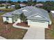 Inviting single-story home features a well-manicured lawn, attached two-car garage and covered entryway with glass paneled front door at 4062 Green Tree Ave, Sarasota, FL 34233
