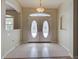 Foyer area featuring tiled floors, chandelier, and decorative double doors at 4062 Green Tree Ave, Sarasota, FL 34233