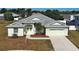 An eye-level front exterior showcasing the home's manicured lawn and welcoming double door entrance at 4062 Green Tree Ave, Sarasota, FL 34233