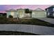Charming one-story home with a two-car garage, lush landscaping, and a welcoming front entrance at 4062 Green Tree Ave, Sarasota, FL 34233