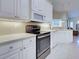 Modern kitchen with white cabinets, stainless steel appliances, and ample countertop space at 4062 Green Tree Ave, Sarasota, FL 34233