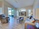 Comfortable living room with built-in shelving, hardwood floors, and a view to the outside patio at 4062 Green Tree Ave, Sarasota, FL 34233
