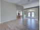 Open-concept living room showcasing hardwood floors, arched entryways and double front doors at 4062 Green Tree Ave, Sarasota, FL 34233