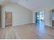 Bright, open-concept living room featuring hardwood floors and a sliding glass door to the patio at 4062 Green Tree Ave, Sarasota, FL 34233