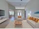 Living room showcasing an open floor plan with views of the dining area and front entrance at 4062 Green Tree Ave, Sarasota, FL 34233