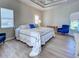 Spacious main bedroom with tray ceiling, ceiling fan, and bright windows at 4062 Green Tree Ave, Sarasota, FL 34233
