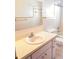 A tiled bathroom features a vanity with a sink and faucet at 407 Bahama Rd, Venice, FL 34293