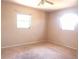 The bedroom has neutral walls, carpet flooring and two windows providing natural light at 407 Bahama Rd, Venice, FL 34293