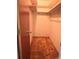 Walk-in closet with carpet flooring and built-in shelving and hanger rods at 407 Bahama Rd, Venice, FL 34293