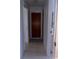 A tiled hallway features closed wooden doors on either side at 407 Bahama Rd, Venice, FL 34293
