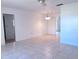 Bright living room featuring tile floors, ceiling fan, and adjacent doorways to other rooms at 407 Bahama Rd, Venice, FL 34293