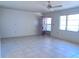 Spacious living room featuring tile flooring, ceiling fan and lots of natural light at 407 Bahama Rd, Venice, FL 34293