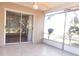 View of a covered patio featuring tile flooring, a ceiling fan, and a screened-in enclosure at 407 Bahama Rd, Venice, FL 34293