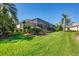 Beautiful backyard featuring a screened lanai and lush landscaping at 4326 Corso Venetia Blvd, Venice, FL 34293
