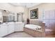 Bathroom featuring a soaking tub, tiled shower, and a large mirror over the vanity at 4326 Corso Venetia Blvd, Venice, FL 34293
