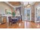 Cozy dining room featuring hardwood floors, an elegant chandelier, and seating for four at 4326 Corso Venetia Blvd, Venice, FL 34293