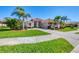 Beautiful one-story home with a tile roof, lush landscaping, and a paver driveway for curb appeal at 4326 Corso Venetia Blvd, Venice, FL 34293