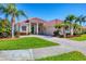 Beautiful one-story home with a tile roof, lush landscaping, and a paver driveway for curb appeal at 4326 Corso Venetia Blvd, Venice, FL 34293