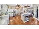 Bright kitchen with white cabinets, stainless steel appliances, and a breakfast bar with seating at 4326 Corso Venetia Blvd, Venice, FL 34293