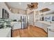 Well-lit kitchen boasting white cabinets, stainless steel appliances, and hardwood floors at 4326 Corso Venetia Blvd, Venice, FL 34293
