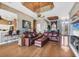 Warm and inviting living area with hardwood floors, comfortable seating, and a view of the lake at 4326 Corso Venetia Blvd, Venice, FL 34293