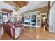 Open living area with hardwood floors, a built-in entertainment center, and access to other rooms at 4326 Corso Venetia Blvd, Venice, FL 34293