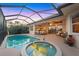 Outdoor screened-in pool and spa area with an extended patio for outdoor entertaining at 4326 Corso Venetia Blvd, Venice, FL 34293