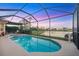 Beautiful screened-in pool and spa area with scenic lake views, ideal for outdoor enjoyment at 4326 Corso Venetia Blvd, Venice, FL 34293