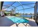 Beautiful screened-in pool area with a serene lake view perfect for relaxation at 4326 Corso Venetia Blvd, Venice, FL 34293