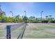 An inviting tennis court on a sunny day, perfect for enjoying outdoor recreation and friendly competition at 4326 Corso Venetia Blvd, Venice, FL 34293