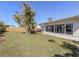 The spacious backyard has a tree that provides shade for outdoor activities at 444 Driftwood Rd, Venice, FL 34293