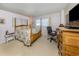 Cozy bedroom with a floral-patterned bed, providing a comfortable retreat for relaxation and rest at 444 Driftwood Rd, Venice, FL 34293
