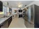 Efficient kitchen with stainless steel refrigerator and black and white cabinetry offering a clean and functional cooking space at 444 Driftwood Rd, Venice, FL 34293
