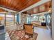 Spacious sunroom with wood ceiling and a built-in bookcase at 444 Driftwood Rd, Venice, FL 34293