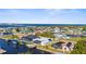 Aerial view features waterfront homes along canals with boat docks and screened pools in a sunny area at 5265 Neville Ter, Port Charlotte, FL 33981