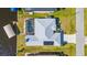 An aerial view of a home, pool, boat dock, and canal on a sunny day at 5265 Neville Ter, Port Charlotte, FL 33981